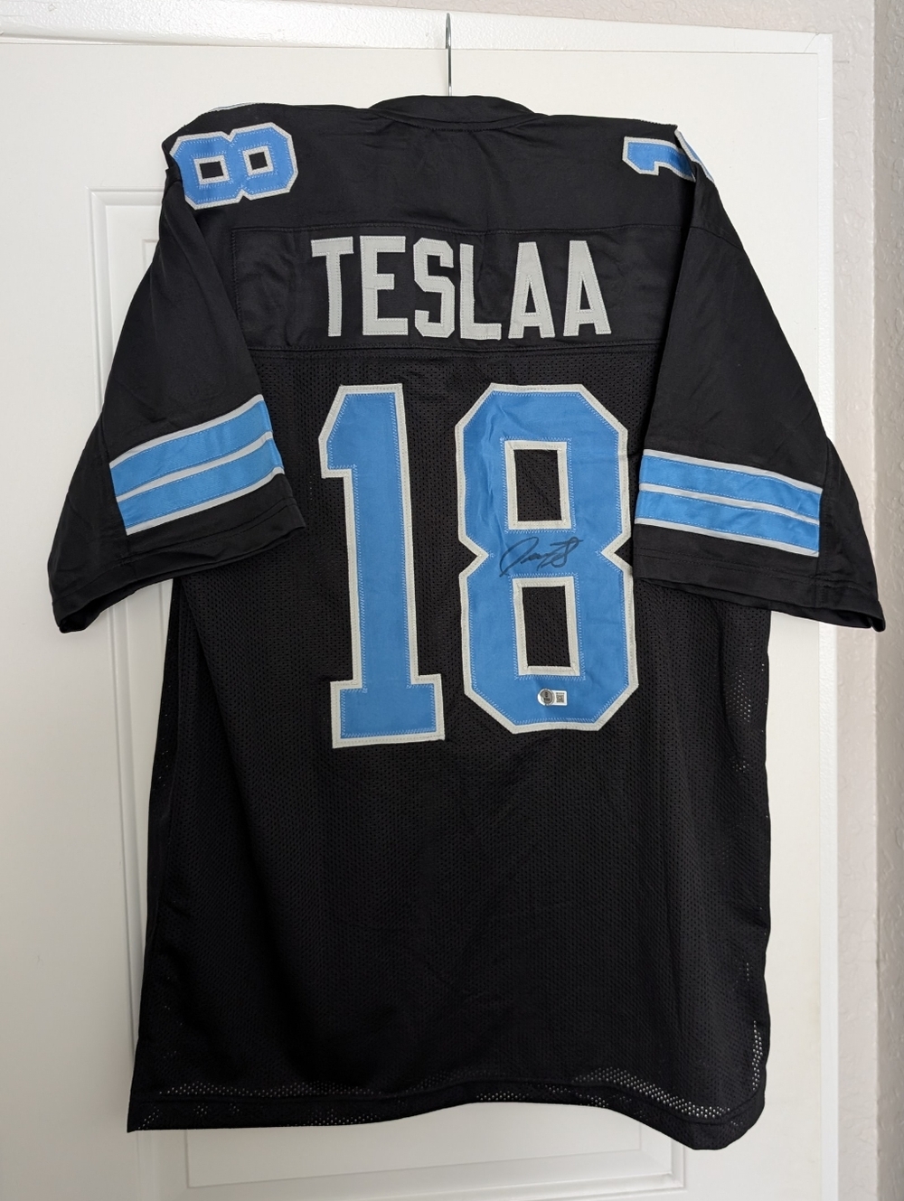 Isaac Teslaa Autographed Football Jersey